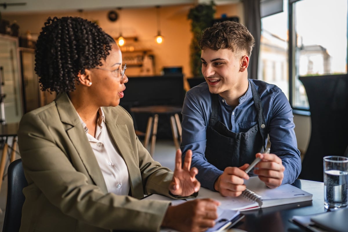 Young entrepreneur analyzing a project with a financial adviser